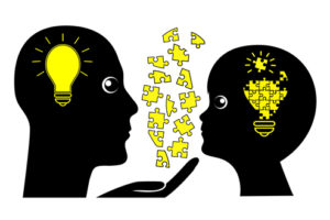 A silhouette of a teacher explaining a concept to a child.