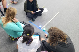 girls on a blacktop completing a challenge with their Spheros