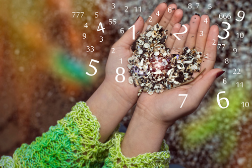 a little girl's hand with math symbols in the shape of a heart