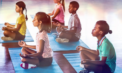 Children on mats, meditating