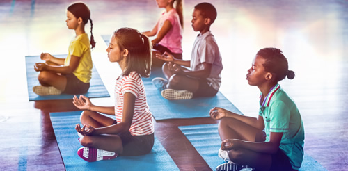 Children on mats, meditating