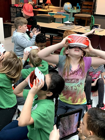 Students doing a virtual field trip with Google Expeditions