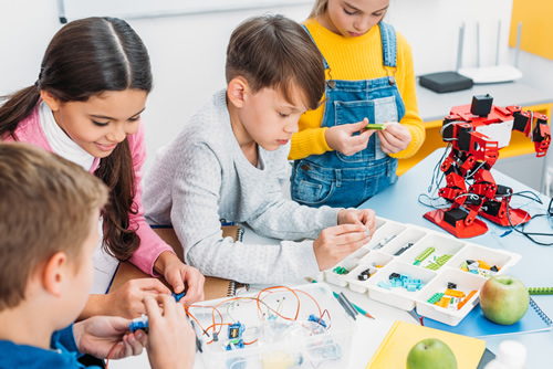Young students building a robot