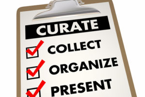 A clipboard with the words curate, collect, organize, and present