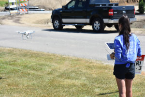 a high school student flying a drone