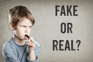a little boy with a questioning look and the words "Fake or Real?"