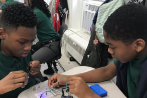 Two students at DPA building a robot