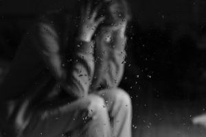 A student sits with her head in her hands, but trauma-informed teaching can help create healthy learning environments.