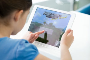 It's easy to start to use Minecraft in the classroom--here, a young student plays Minecraft on an iPad.