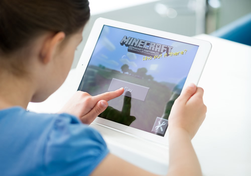 It's easy to start to use Minecraft in the classroom--here, a young student plays Minecraft on an iPad.
