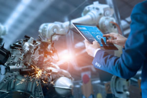 Engineer manager checking and controlling automation robot arms machine and robotics in intelligent factory industrial on real time monitoring system software.