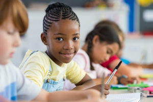 Chicago teacher Quinlan O’Grady is preparing her students for success with video lessons that promote active learning through mindfulness instruction, as seen by this happy student in school.