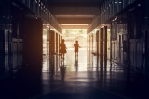 School safety is important, as seen by these two students walking in a school hallway.