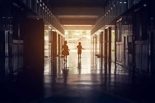 School safety is important, as seen by these two students walking in a school hallway.