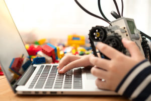 Schools across the globe are making an effort to embed coding and robotics skills and programs into core learning like this Lego Mindstorms boy coding.