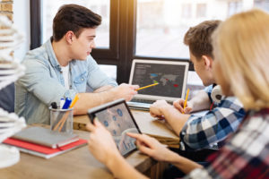 School culture, competing priorities, and teacher agency among the contextual variables selected for further research by the EdTech Genome Project, like these students sitting working on laptops and tablets.