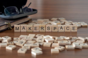 The concept of a school makerspace is represented by loose wooden tiles.