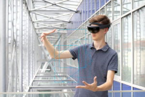 Young readers read scientific text using mixed reality glasses to deliver supplementary content in the virtual world