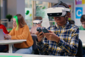 As new education trends lead to innovative teaching and learning, here are some of the top trends to look for, like this student wearing a VR headset in the classroom.
